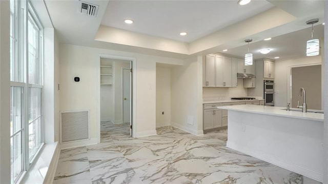 kitchen with gas cooktop, pendant lighting, plenty of natural light, and sink