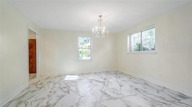 spare room with a notable chandelier