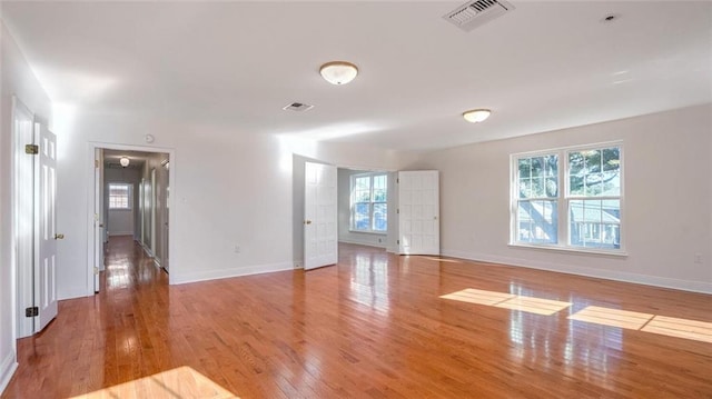 unfurnished room featuring basketball court and light hardwood / wood-style flooring