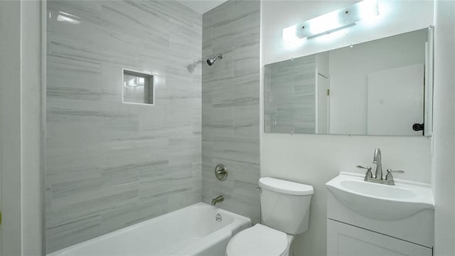 full bathroom with vanity, tiled shower / bath, and toilet