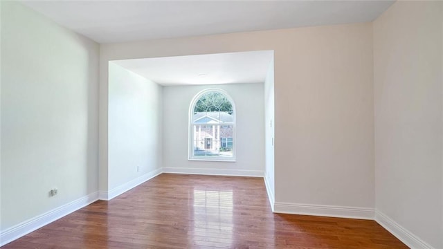 empty room with hardwood / wood-style floors