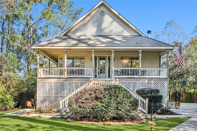 view of front of house with covered porch and a front lawn