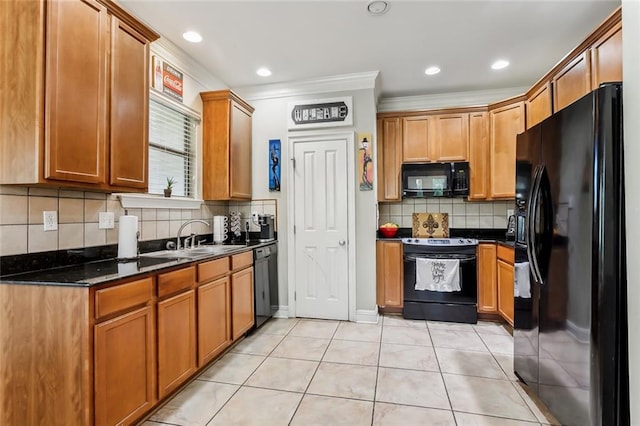 kitchen with dark stone countertops, tasteful backsplash, crown molding, and black appliances