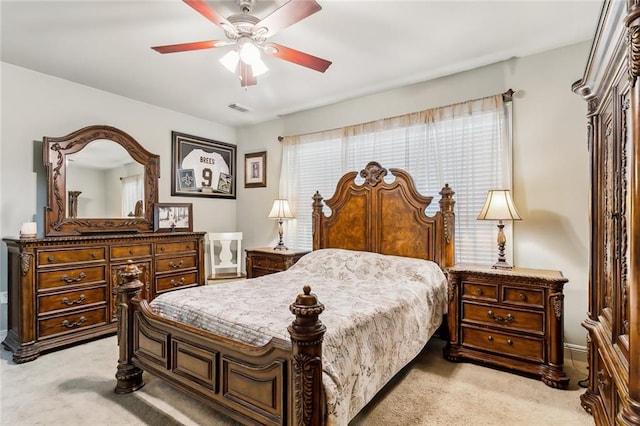 bedroom featuring light carpet and ceiling fan