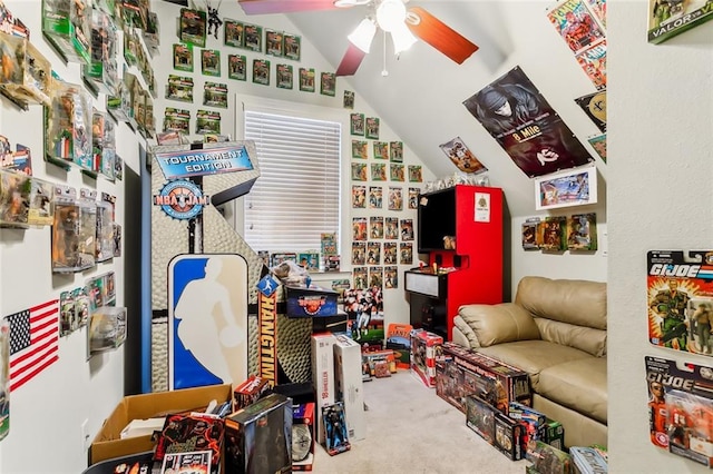 playroom with ceiling fan, light colored carpet, and vaulted ceiling