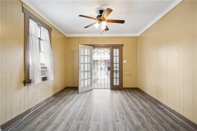 spare room with ornamental molding, hardwood / wood-style floors, ceiling fan, and cooling unit