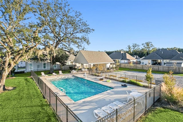 view of pool with a fenced in pool, a patio, a residential view, fence, and a yard