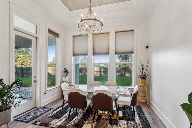 sunroom with a chandelier and a tray ceiling