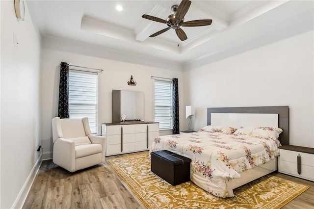 bedroom featuring coffered ceiling, wood finished floors, baseboards, beamed ceiling, and crown molding