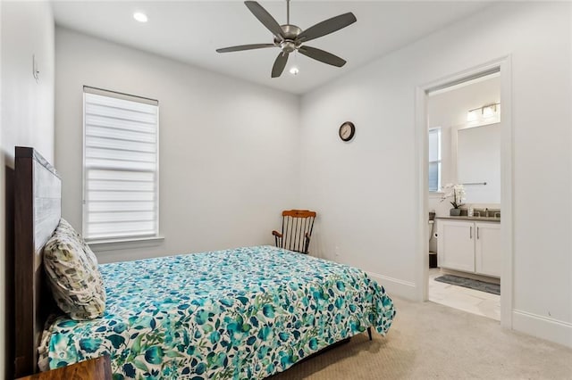 bedroom with baseboards, recessed lighting, connected bathroom, and light colored carpet