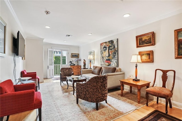 living room featuring crown molding and light hardwood / wood-style flooring