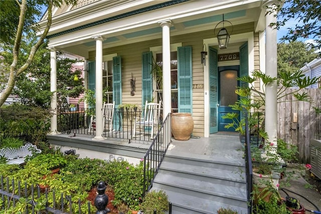 view of exterior entry with covered porch