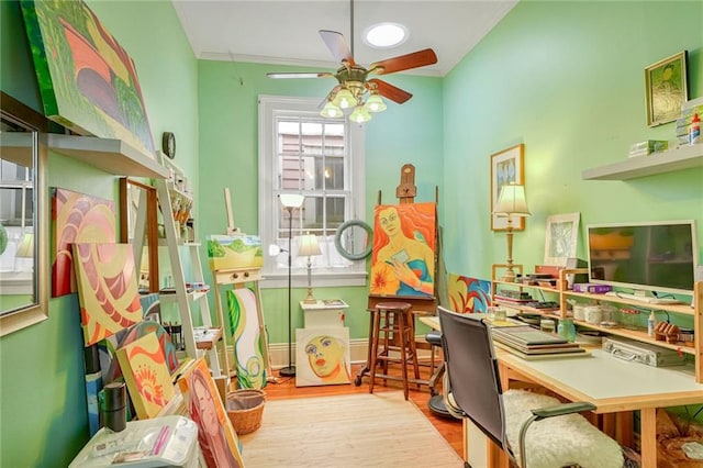 recreation room featuring ceiling fan, ornamental molding, and light hardwood / wood-style flooring