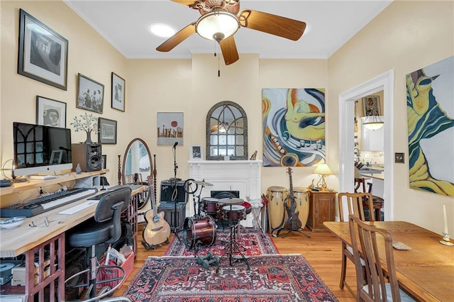 home office with ceiling fan, light wood-type flooring, and crown molding