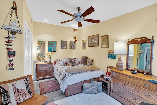 bedroom featuring light carpet and ceiling fan