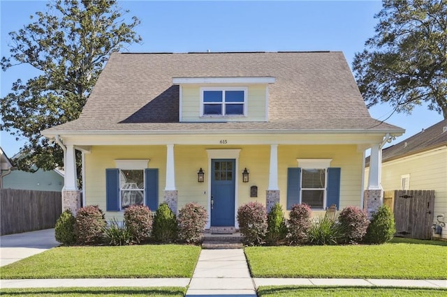 view of front of house featuring a front yard and covered porch