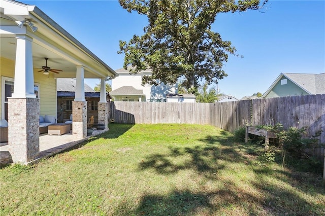 view of yard featuring ceiling fan and a patio