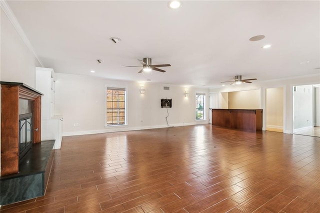 unfurnished living room with dark hardwood / wood-style floors, plenty of natural light, and ceiling fan