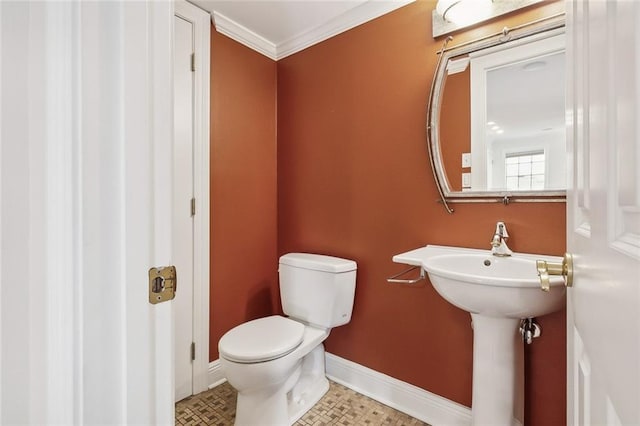 bathroom with toilet and crown molding