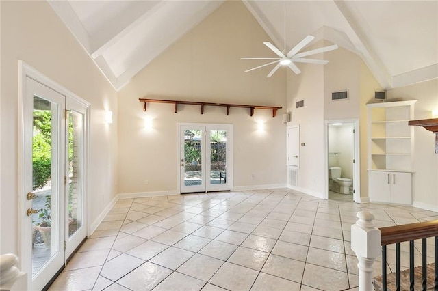 unfurnished living room with french doors, light tile patterned floors, high vaulted ceiling, and ceiling fan