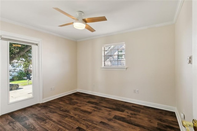 spare room with plenty of natural light, dark hardwood / wood-style floors, ornamental molding, and ceiling fan