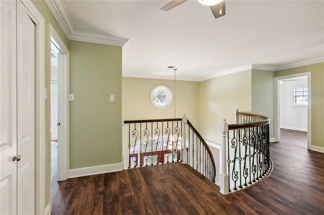 stairway with wood-type flooring, ceiling fan, and ornamental molding