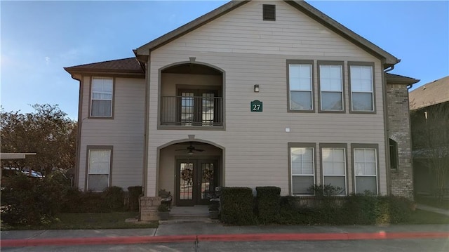 view of front facade featuring a balcony and french doors