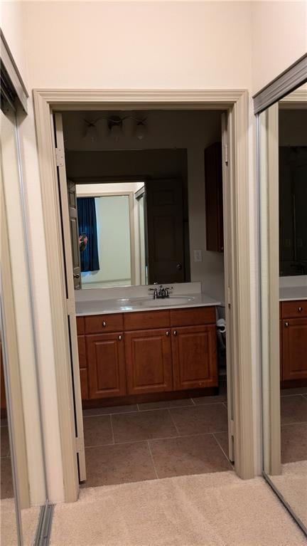 bathroom with tile patterned floors and vanity