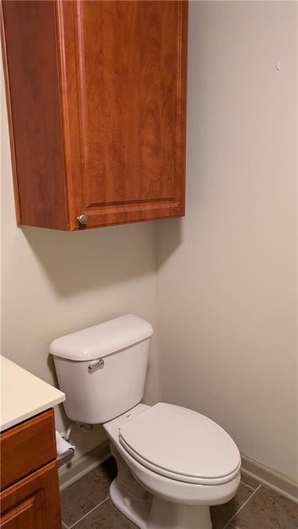 bathroom featuring tile patterned flooring, vanity, and toilet