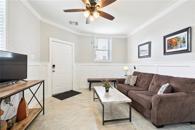 living room with ceiling fan and ornamental molding