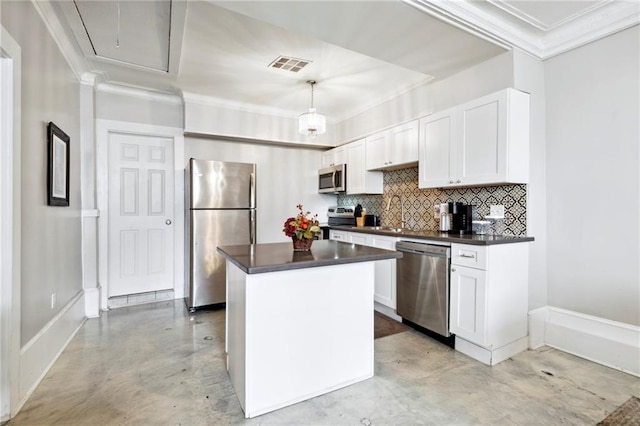 kitchen featuring white cabinets, appliances with stainless steel finishes, a kitchen island, and pendant lighting