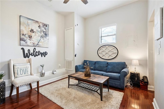 living room featuring dark hardwood / wood-style floors and ceiling fan