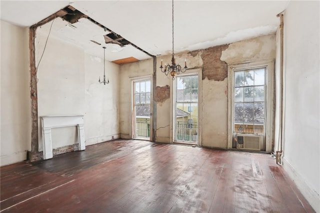 unfurnished dining area with cooling unit, dark hardwood / wood-style flooring, and a chandelier