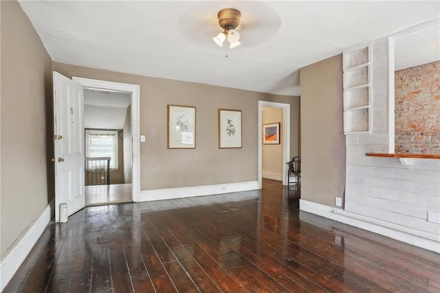 unfurnished living room featuring dark hardwood / wood-style floors and ceiling fan