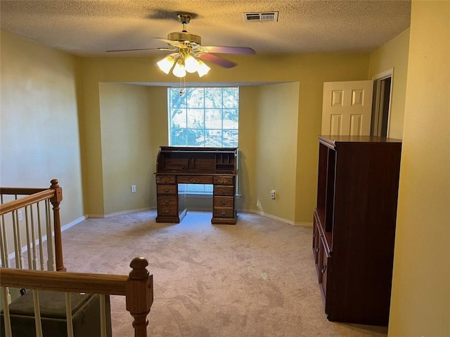 interior space with light carpet, a textured ceiling, and ceiling fan