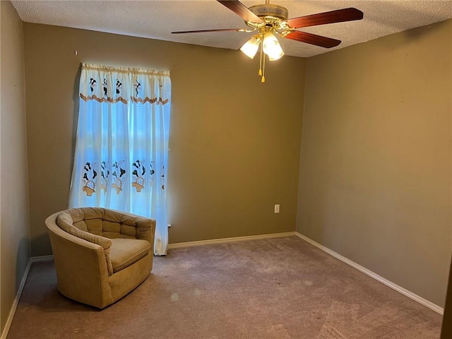 unfurnished room featuring carpet flooring, a textured ceiling, and ceiling fan