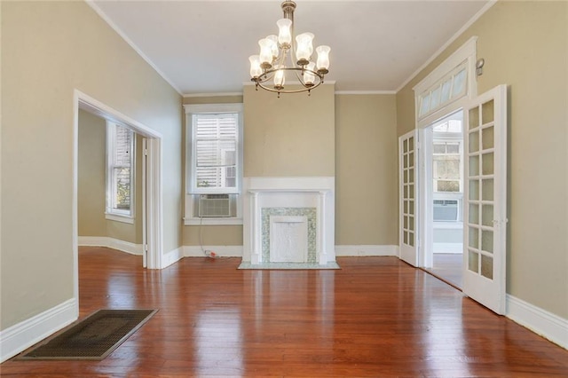 1127 Fern St, New Orleans, LA 70118 - unfurnished living room with a chandelier, ornamental molding, wood finished floors, baseboards, and cooling unit