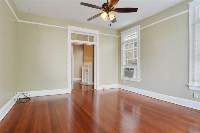 unfurnished room featuring wood-type flooring, ceiling fan, and cooling unit