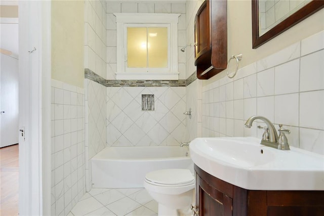 full bathroom featuring tile patterned floors, vanity, tile walls, and toilet