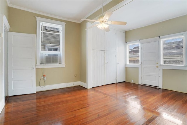 unfurnished bedroom with ceiling fan, hardwood / wood-style floors, and ornamental molding