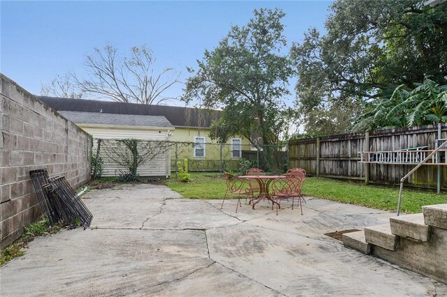 1127 Fern St, New Orleans, LA 70118 - fenced backyard featuring a patio and outdoor dining space
