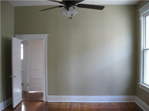 spare room with ceiling fan and dark hardwood / wood-style flooring