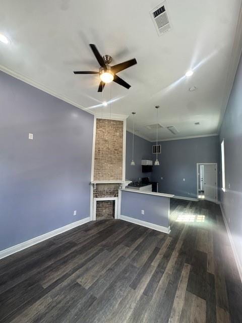 unfurnished living room with crown molding, a fireplace, ceiling fan, and dark hardwood / wood-style floors