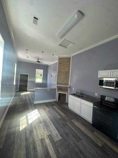 kitchen featuring white cabinets, dark hardwood / wood-style flooring, black electric range oven, and sink