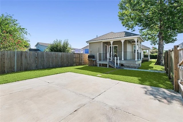 view of front of home with covered porch, a front lawn, and a fenced backyard