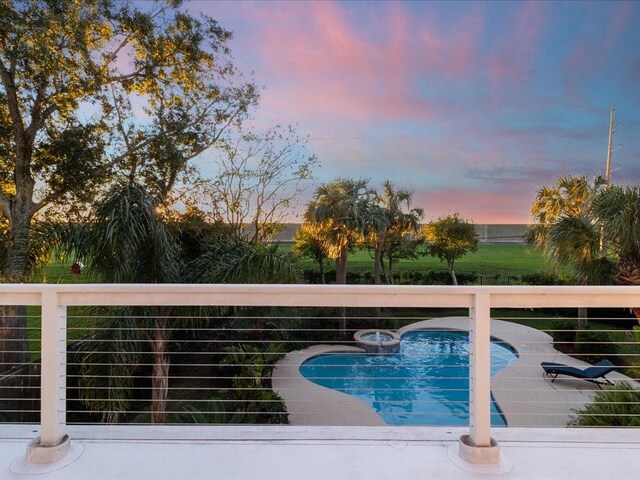 view of pool at dusk