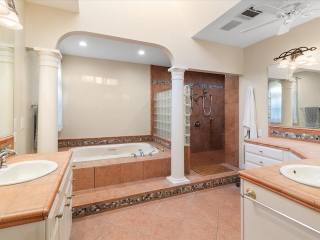 bathroom featuring tile patterned flooring, vanity, and plus walk in shower