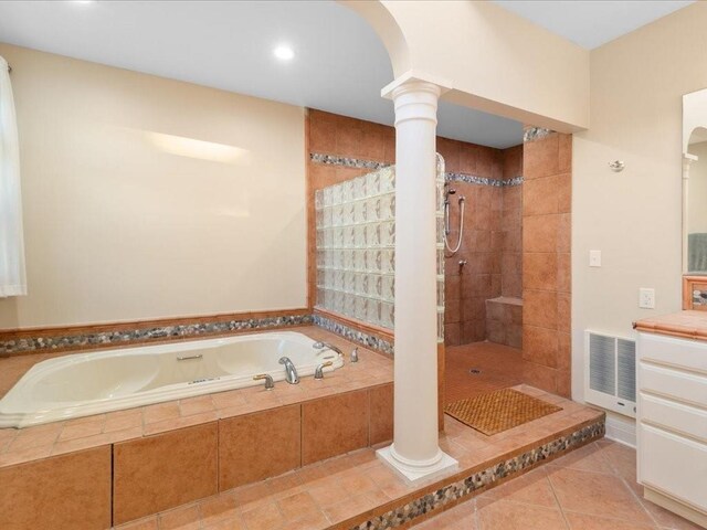 bathroom with shower with separate bathtub, tile patterned floors, and ornate columns