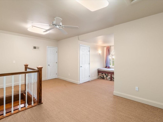 unfurnished room featuring ceiling fan and light colored carpet