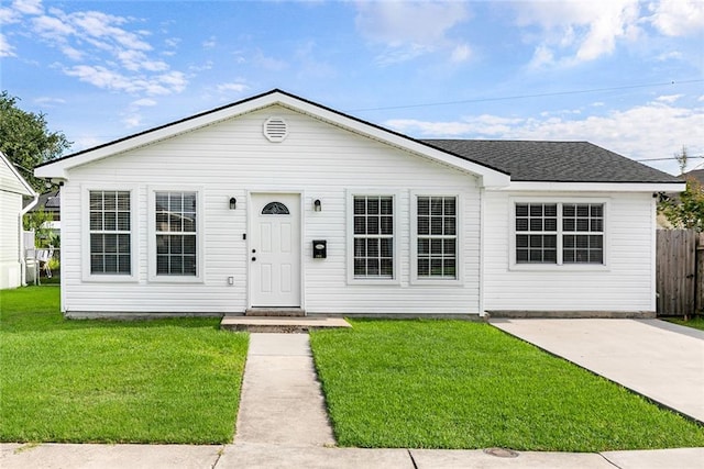 ranch-style home with a front lawn